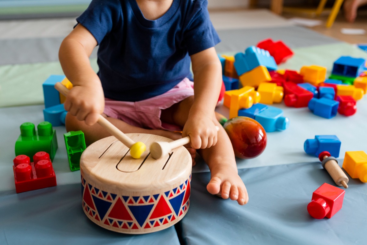 Image of a child playing a toy drum